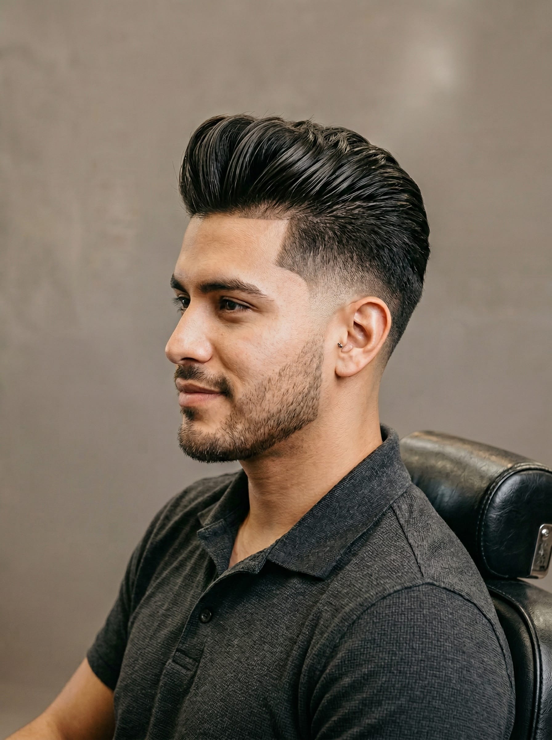 Modern Pompadour haircut — Volume swept up and back off the forehead, sides faded clean